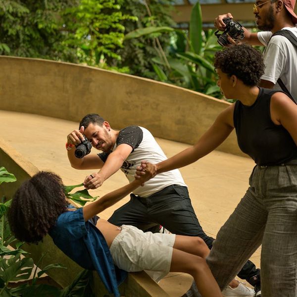 A diverse group of people smiling during a light yoga session.